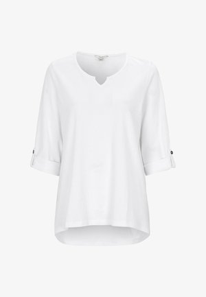White, three-quarter sleeve top made of soft material. V-neck design with rolled sleeves and button accents, featuring a slightly curved hem.