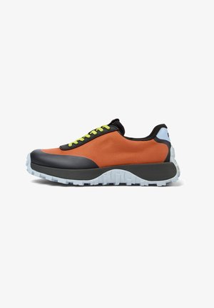 Black and orange sneaker with a textured fabric upper, green laces, and a thick, white rubber tread sole. Lightweight design with accent details.