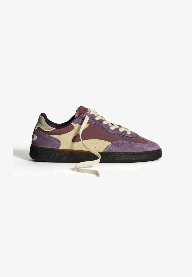 Purple, beige, and maroon low-top sneaker with beige laces, black sole, and suede and fabric materials on a white background.