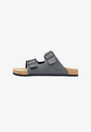 Black slip-on sandal with two adjustable buckle straps, cork footbed, and black sole, side view.