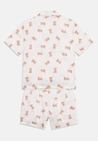 Kortärmad pyjamaset i vitt tyg med ett teddy-björnstyr. Topp med krage; shortsen har en elastisk midja.