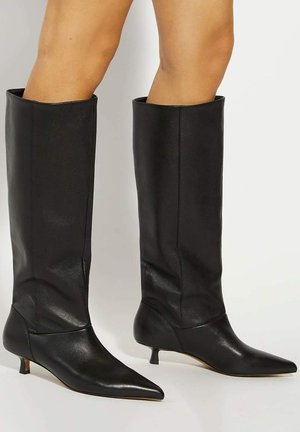 Black leather knee-high boots with a pointed toe, kitten heel, and smooth texture. Fitted design with a sleek appearance.