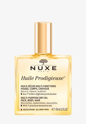 Nuxe Huile Prodigieuse olio secco multiuso per viso, corpo e capelli con sette oli botanici, in una bottiglia quadrata trasparente da 100 ml con tappo dorato.