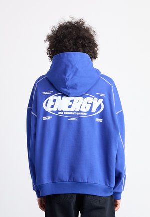 Blue hoodie with a large white "ENERGY" graphic on the back. Features contrasting white stitching and a drawstring hood. Soft texture.