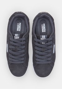 Black suede sneakers with round toe, thick black laces, and white rubber soles. Features brand logo on tongue and side.