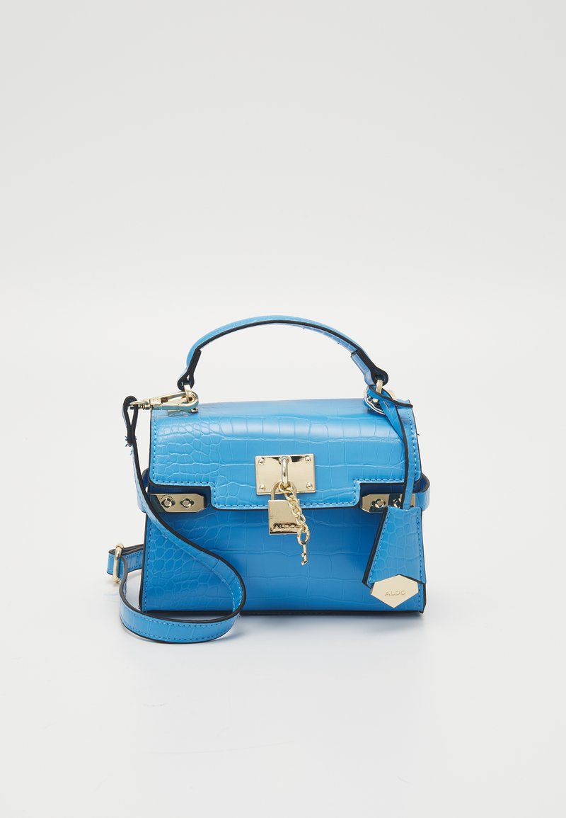 Blue, croc-embossed handbag with a top handle, adjustable strap, gold hardware, and a clasp closure. Notable tag accent included.
