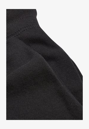 Tessuto nero con una trama a coste che mostra le cuciture. Il materiale è morbido e leggermente elastico, senza motivi o dettagli notevoli.