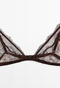 Brown lace bra featuring intricate floral patterns, adjustable straps, and a front clasp closure. Lightly sheer with scalloped edges.