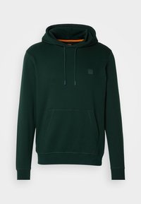 Felpa verde scuro con tasca a kangaroo, cappuccio regolabile con coulisse e un piccolo logo sul petto. Tessuto morbido.