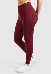 Bordeaux nauwsluitende hoge taille legging gemaakt van rekbare stof, met een gladde textuur en een strakke pasvorm met een naadloze tailleband.