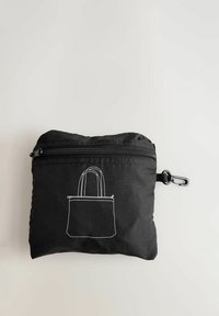 Melna kompakta somiņa no mīksta auduma ar rāvējslēdzēju un stiprinājumu. Priekšpusē ir baltas kontūras ilustrācija ar iepirkumu maisiņu.