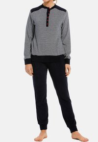 Marinblå randig loungedräkt bestående av en långärmad topp med röda knappar och en enfärgad marinblå underdel. Mjuk tyg med ribbade manschetter.