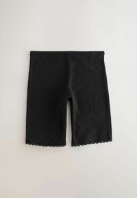 Fekete biciklis rövidnadrág sima anyagból, csipkebetéttel a szegély mentén. Rugalmas derékpánttal tervezték a kényelem érdekében.