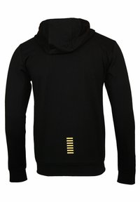 Black hoodie with a soft texture, featuring a large hood and a vertical yellow stripe detail at the back near the hem.