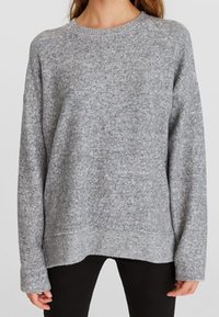 Grå strikket sweater med rund halsudskæring, lange ærmer og afslappet pasform. Har en tekstureret finish samt ribbede manchetter og afslutning.
