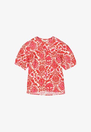 Blouse à manches courtes en coton vibrant rouge et rose, présentant des motifs floraux et géométriques avec un design à boutons sur le devant.