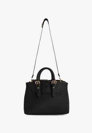 Sac à main noir avec double poignées, accents de boucle dorée et une bandoulière longue et réglable, présenté sur fond blanc.