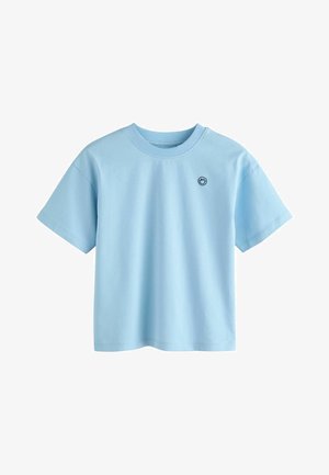 Svjetloplava pamučna majica s okruglim izrezom, kratkim rukavima i malim crnim logotipom otisnutim na lijevoj strani prsnog koša. Jednostavan i ležeran dizajn.