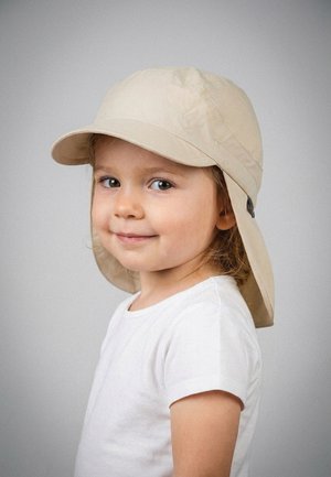 Young child with light brown hair wearing a beige sun hat and white t-shirt, smiling slightly, facing left against a plain gray background.