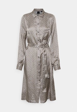 Kleid aus gemustertem Stoff in Beige und Schwarz mit Knopfleiste. Hat lange Ärmel und einen Bindegürtel in der Taille.