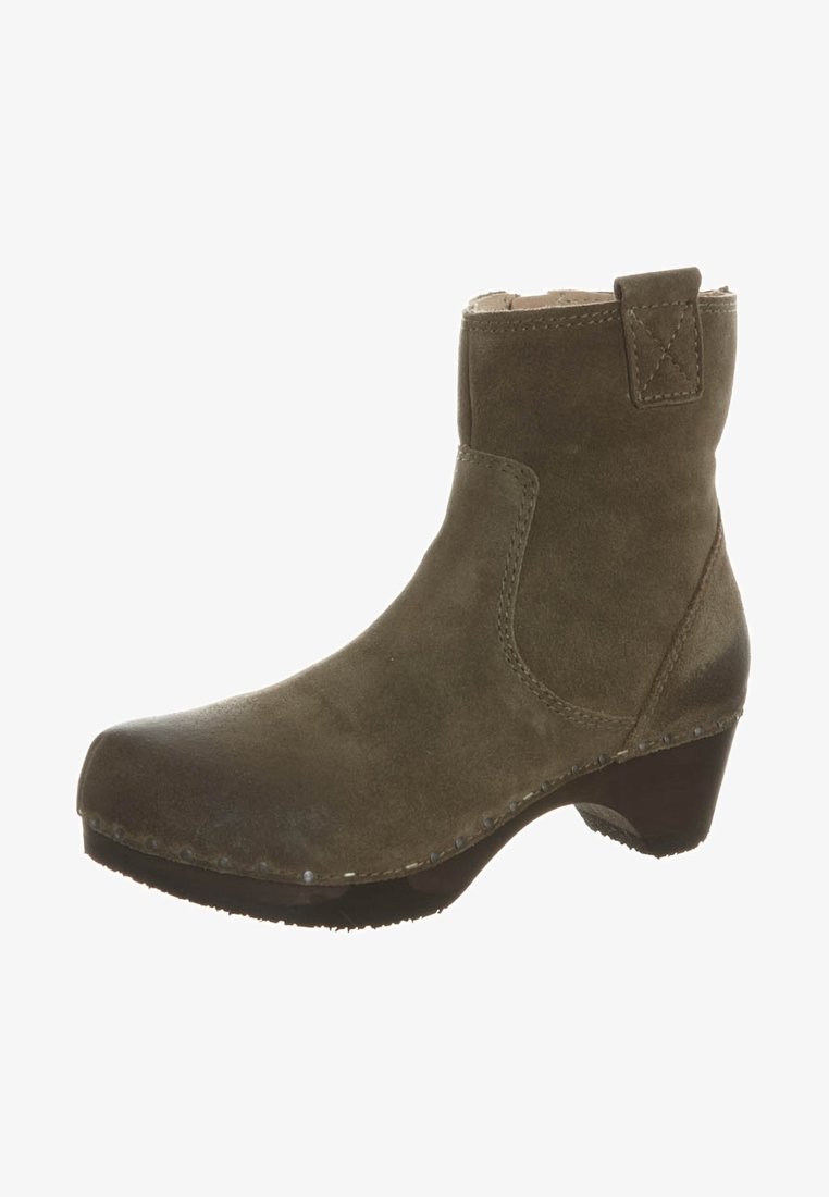 Ruske nubuk ankle boot sa niskim drvenim potplatom, zaobljenim vrhom i petnom petljicom, sa vidljivim šavovima i metalnim zakovicama duž đona.