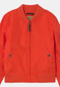 Red bomber jacket made of lightweight, shiny fabric. Features ribbed collar, cuffs, and hem, with zip closure and two side pockets.