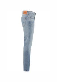 Világoskék skinny farmernadrág. Hátul díszített zsebbel és barna bőr folttal a derékrészen. Klasszikus öt zsebes design.