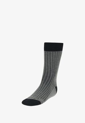 Graue Socken mit einem strukturierten Zickzackmuster, schwarzem Bündchen und Zehen, und aus einem mittelschichtigen Strickstoff, der Flexibilität und Komfort bietet.
