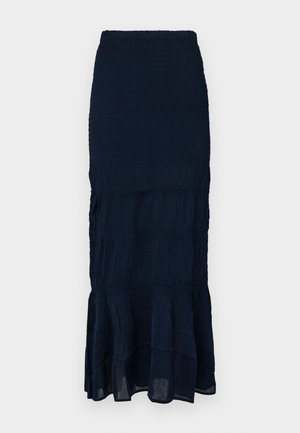 Mörkblå midikjol med smock och en flerskiktad, volangkant med texturerat tyg. Elastisk midja för justerbar passform.