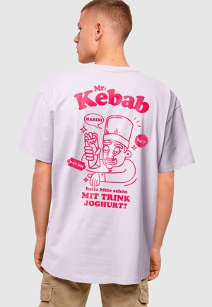 Light purple, short-sleeve t-shirt featuring a graphic of a cartoon chef holding a kebab, with pink text and accents.