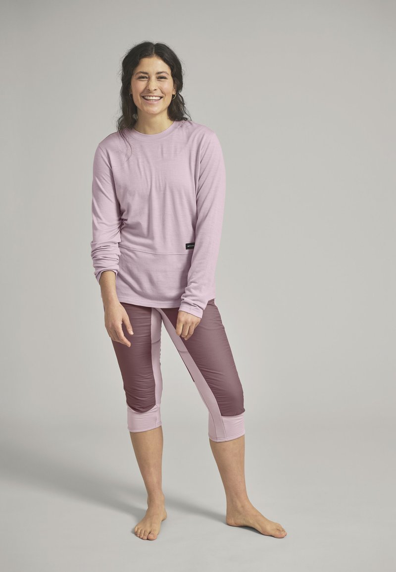 Light pink long-sleeve top and burgundy cropped leggings with pink accents. Soft, fitted design with a smooth texture and crew neck.