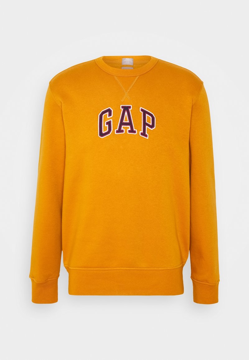 Sudadera de cuello redondo amarilla con "GAP" bordado en púrpura oscuro en el pecho. Puños y dobladillo de canalé, tejido suave.
