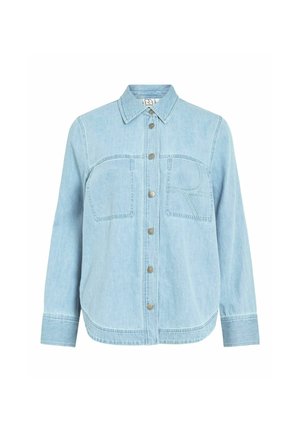 Chemise en denim bleu clair avec boutons, manches longues, deux poches poitrine avant et un motif "R" cousu sur la poche droite.