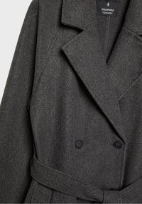 Grey wool-blend coat with a double-breasted design, large lapels, and a belt. It features black buttons and a soft, textured finish.