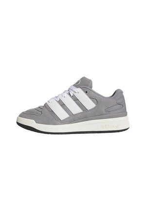 Gray suede sneakers with white leather accents, featuring three white stripes, round toe, and a textured rubber sole.
