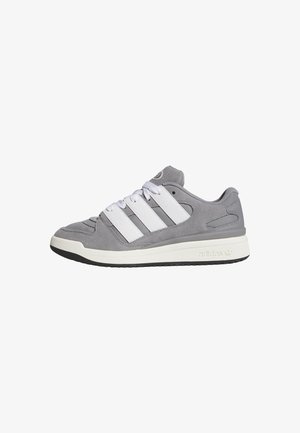Gray suede sneakers with white leather accents, featuring three white stripes, round toe, and a textured rubber sole.