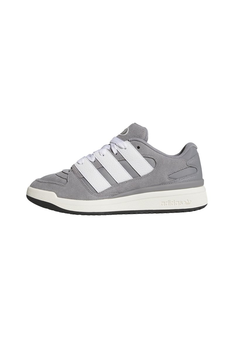 Gray suede sneakers with white leather accents, featuring three white stripes, round toe, and a textured rubber sole.