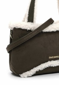 Olivegrøn faux suede håndtaske med hvid fleece kant, korte skulderremme og guldfarvet logo detalje. Kompakt, rektangulær form.