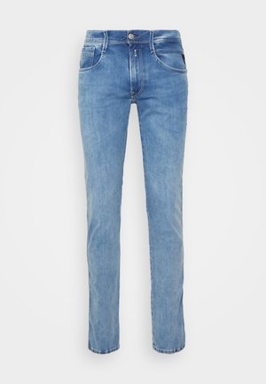Light blue slim-fit denim jeans with front button and zipper, five-pocket design, and subtle fading on legs.
