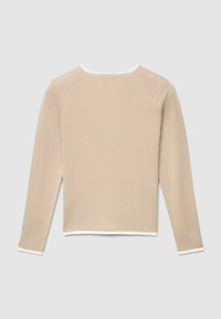 Beige long-sleeve top with a crew neckline, featuring a ribbed texture and white trim along the neckline and sleeves.