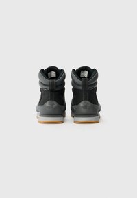 Black waterproof ankle boots with a textured finish, padded collar, and gray accents. Features rubber outsole with a sturdy grip.