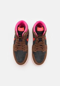 High-top sneakers with dark brown suede, black fabric panels, pink accents, round toe, perforated toe box, and orange logo detail.