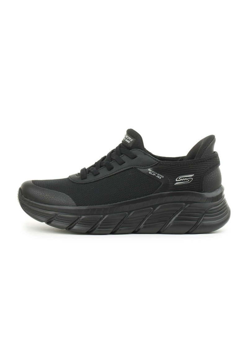 Scarpe sportive nere con tomaia in mesh testurizzato, suola spessa e ammortizzata, e punta rinforzata. Presentano lacci piatti e dettagli del logo sul lato.