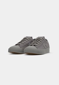 Low-top gray suede sneakers with star logo, rubber soles, and laces, shown side by side on a white background.
