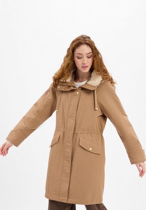 Brown, mid-length parka with a removable fur-lined hood, front pockets, and gold hardware accents; smooth, water-resistant fabric.