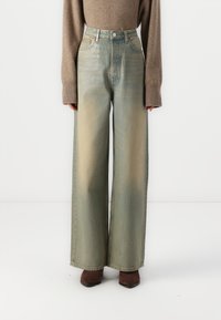 Lyseblå vide jeans med høy livhøyde, med en falmet design, kontrasterende sømmer, samt knapp og glidelås lukking.
