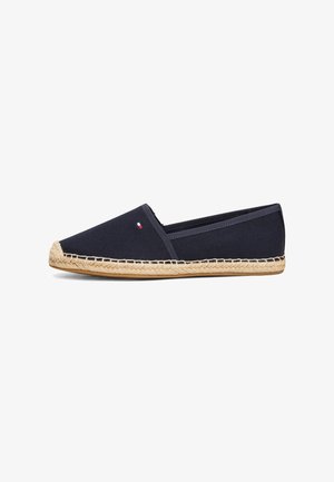 Navy canvas slip-on espadrille with a jute rope sole and a small logo accent. Features a rounded toe and flat heel.