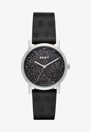 Montre ronde DKNY avec boîtier en argent, cadran noir pailleté, aiguilles argentées et bracelet en cuir noir texturé embossé du logo "DKNY".