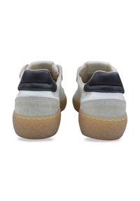 White sneakers with gray suede accents and black leather heel detail. Rubber sole with textured profile. Soft interior lining visible.