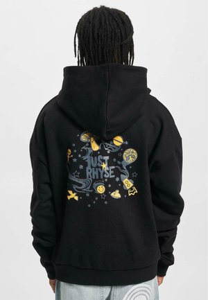 Black hoodie made of soft material, featuring a colorful graphic design on the back with text "JUST RHYSE" and various playful symbols.